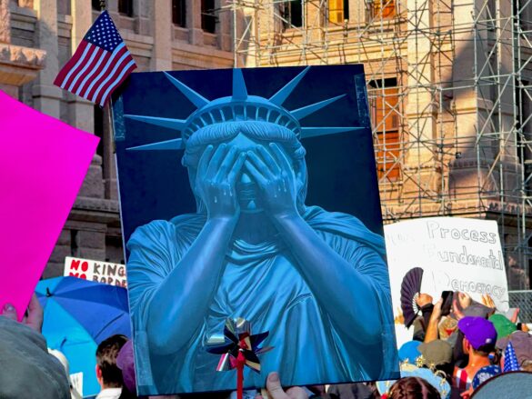 Photo from Austin June 14 protest of a sign featuring the statue of liberty hiding her eyes.