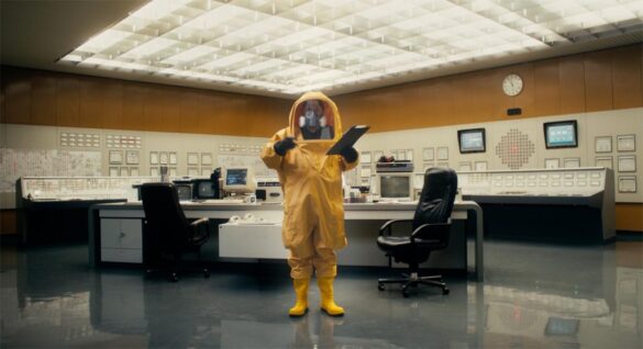 Photo of Johannes Grenzfurthnur in a hazmat suit in "Hacking at Leaves."